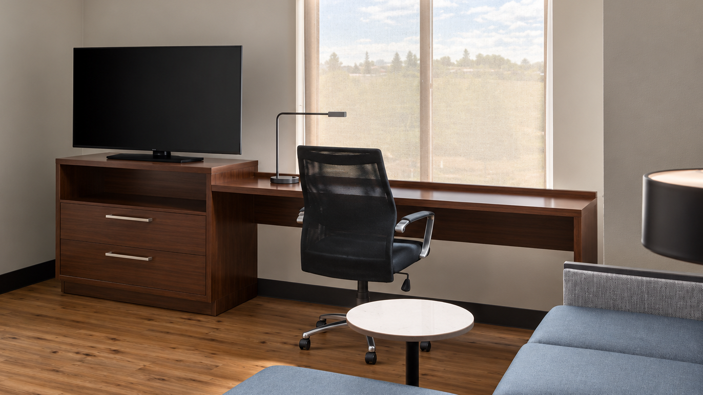hotel desk in guest room with chair